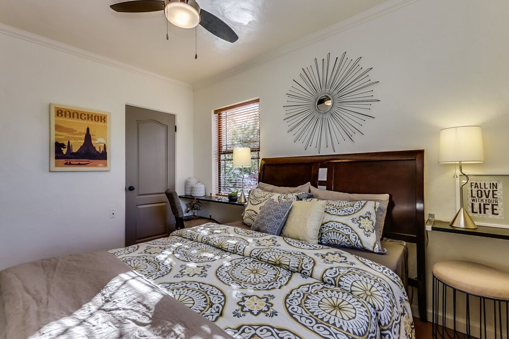 Mid-sized transitional master bedroom in Phoenix with white walls, medium hardwood floors, no fireplace and brown floor.