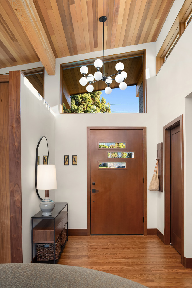 Inspiration for a mid-sized 1950s medium tone wood floor, brown floor and wood ceiling entryway remodel in Seattle with white walls and a medium wood front door