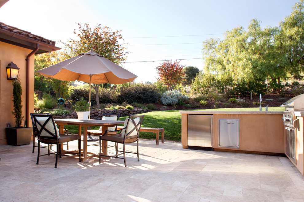 Design ideas for a large mediterranean backyard patio in San Francisco with an outdoor kitchen, natural stone pavers and no cover.
