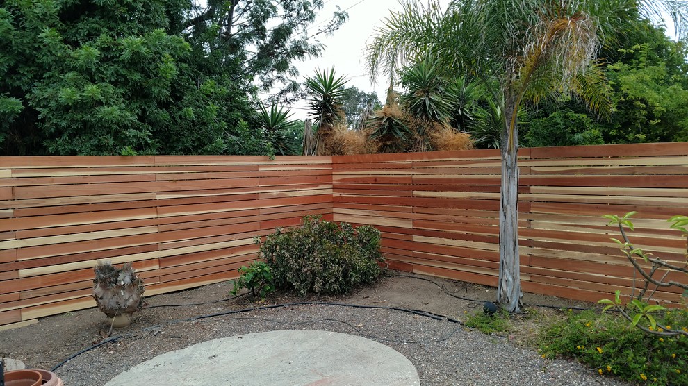 This is an example of a mid-sized contemporary backyard driveway in San Diego.