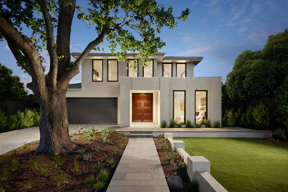 This is an example of a contemporary two-storey beige house exterior in Melbourne with a hip roof.
