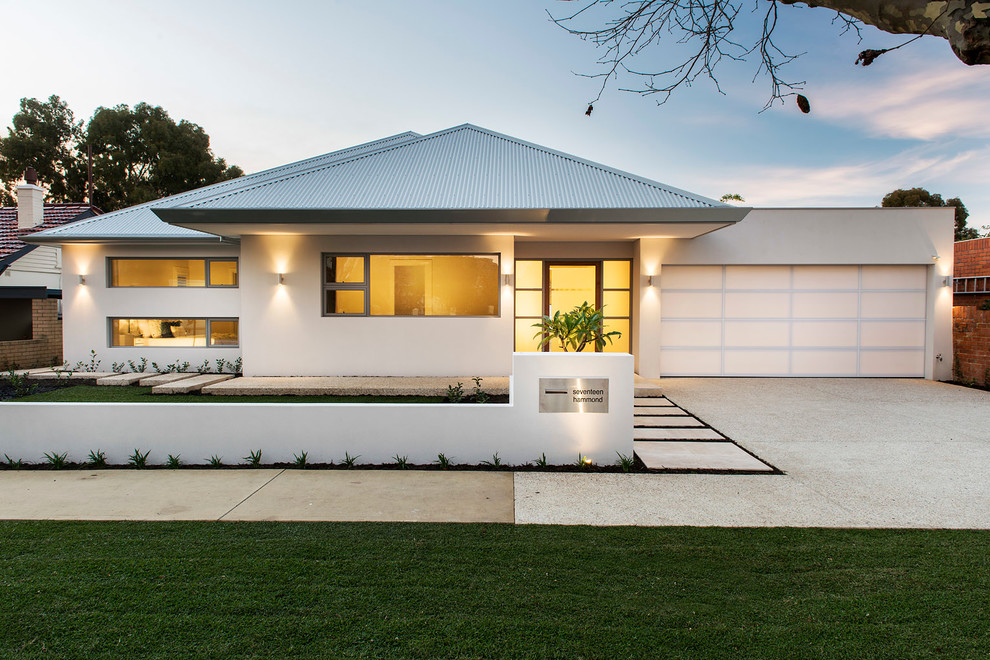 This is an example of a large transitional one-storey white exterior in Perth with a hip roof.