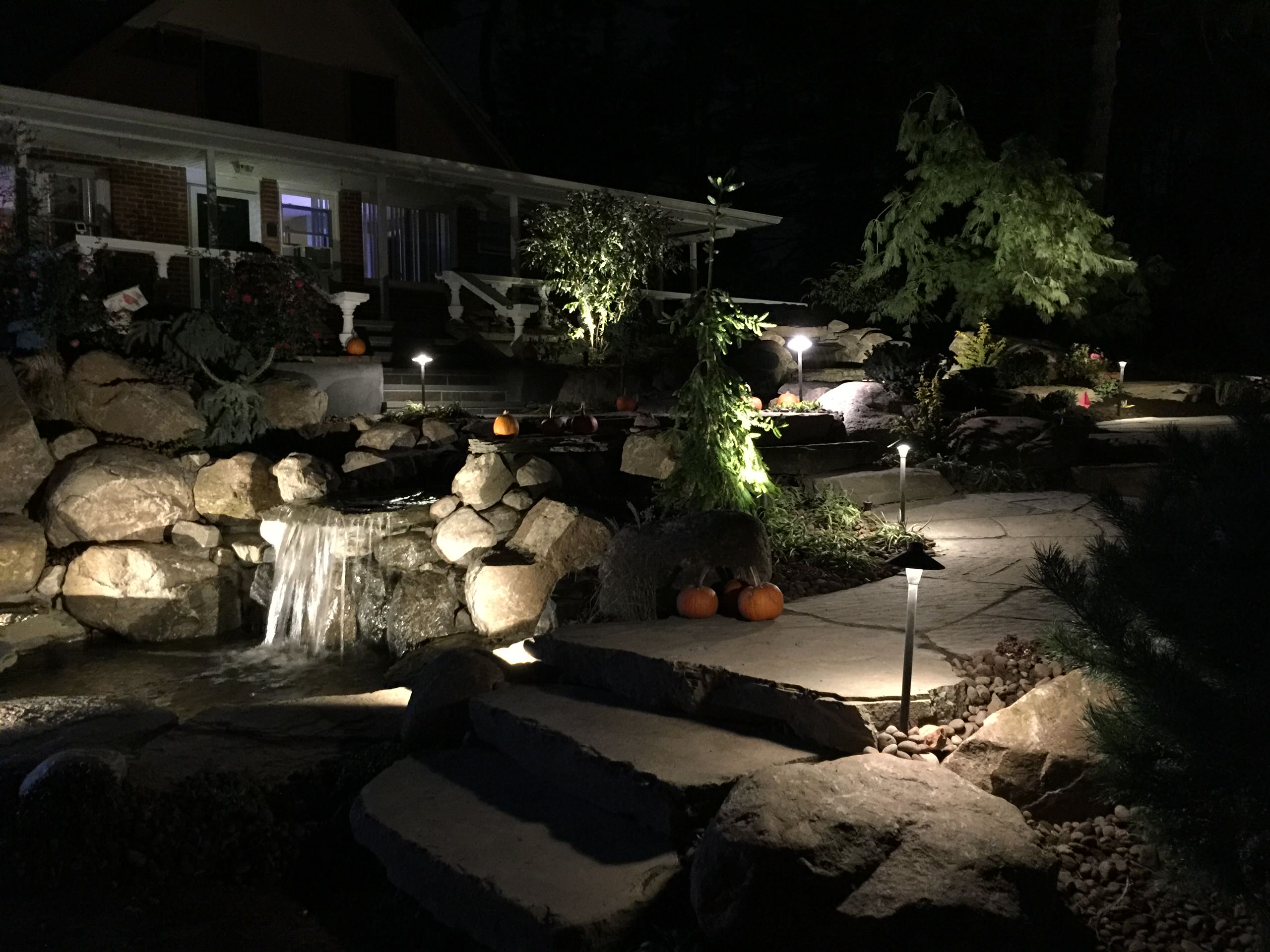 waterfall stream with stone bridge and natural bluestone walkwayway and steps