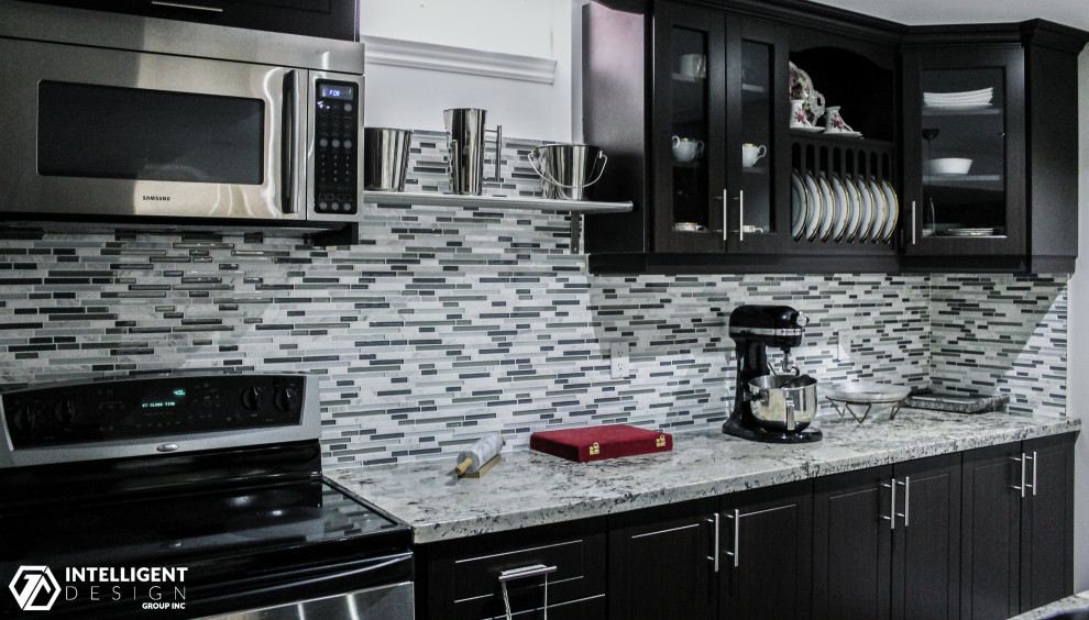 Small transitional single-wall eat-in kitchen photo in Toronto with beaded inset cabinets, dark wood cabinets, marble countertops, multicolored backsplash, glass tile backsplash, stainless steel appliances, no island and gray countertops