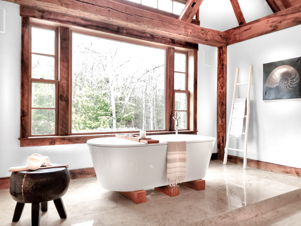 Photo of a large country master bathroom in Bridgeport with a freestanding tub, white walls, porcelain floors, beige floor and vaulted.