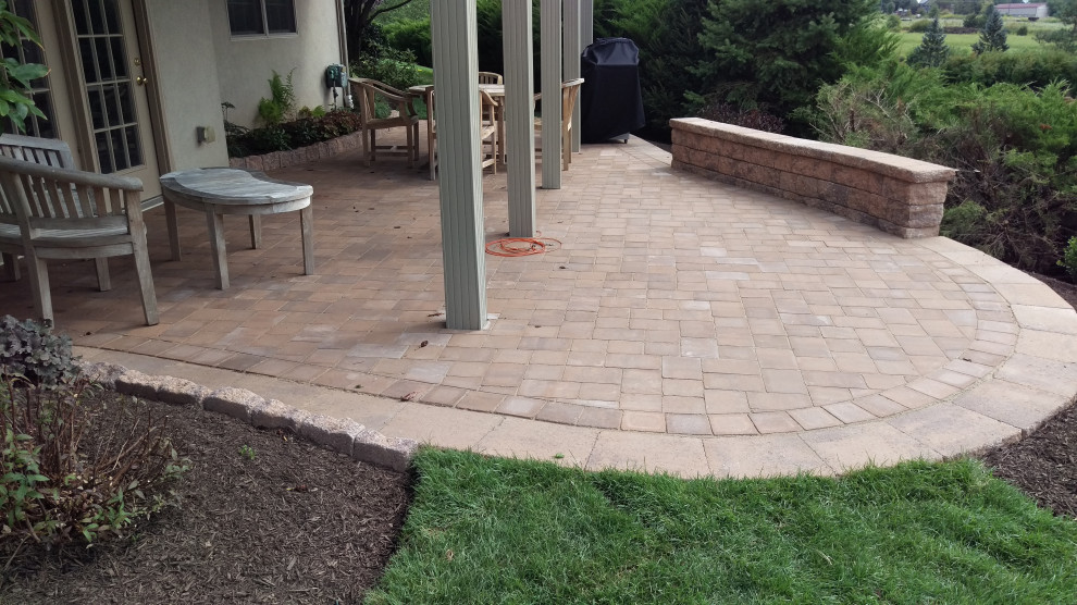 Photo of a small transitional backyard patio in Philadelphia with concrete pavers.