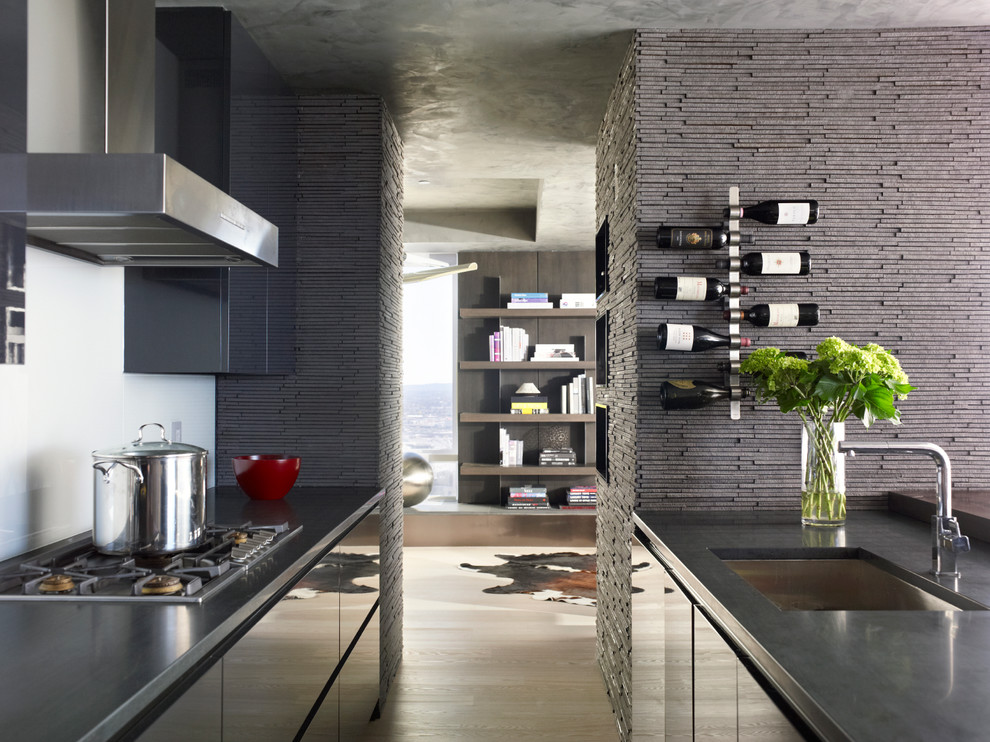 Inspiration for a contemporary galley kitchen in Boston with an undermount sink, flat-panel cabinets, grey cabinets, light hardwood floors and a peninsula.