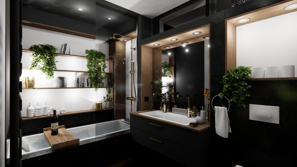Bild på ett mellanstort funkis badrum, med släta luckor, svarta skåp, ett undermonterat badkar, en vägghängd toalettstol, svarta väggar, ett undermonterad handfat, träbänkskiva, cementgolv och svart golv