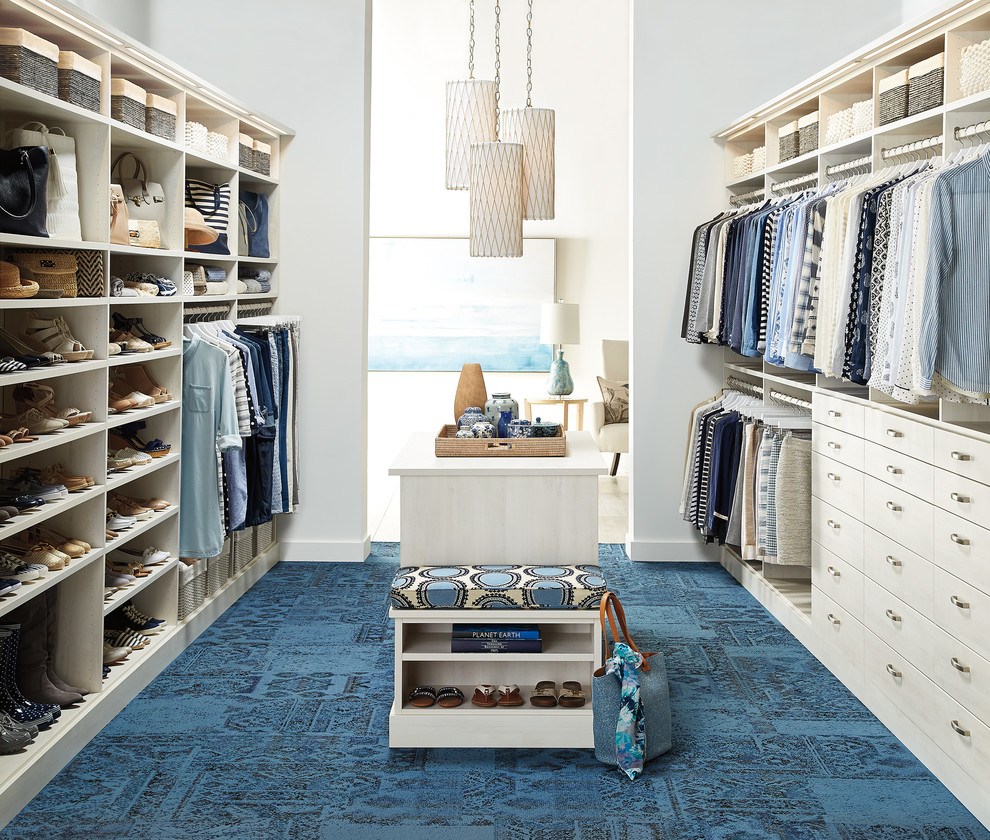Photo of a transitional gender-neutral walk-in wardrobe in Other with flat-panel cabinets, carpet and beige cabinets.