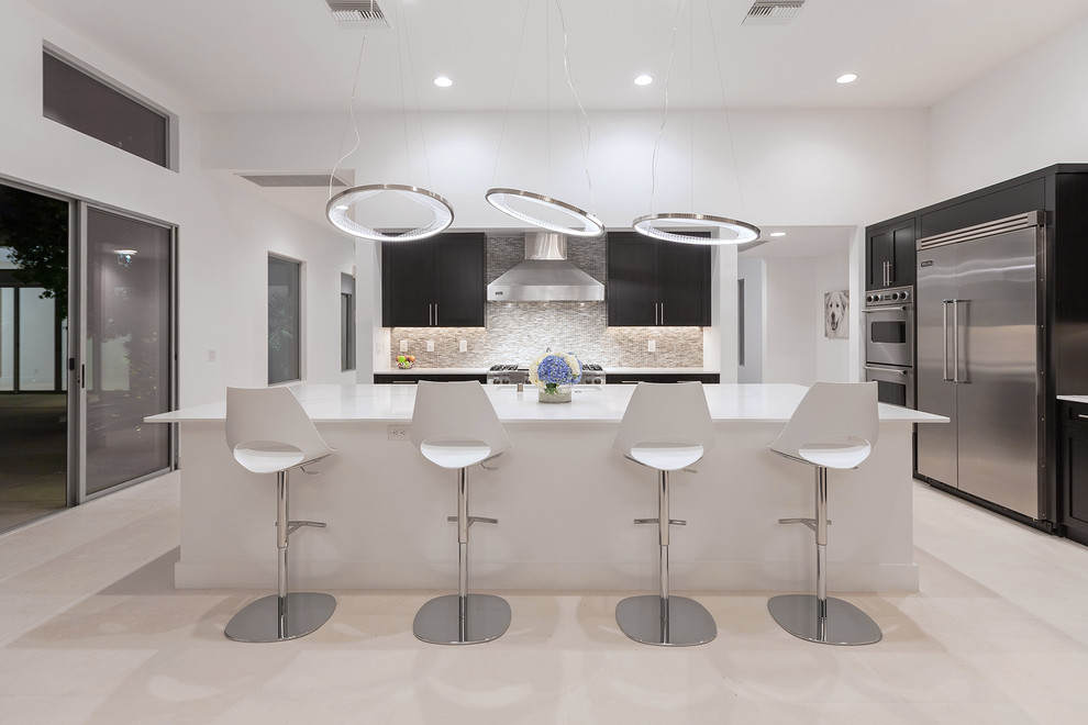 Inspiration for a contemporary kitchen in Las Vegas with shaker cabinets, dark wood cabinets, mosaic tile splashback, stainless steel appliances, with island and multi-coloured splashback.