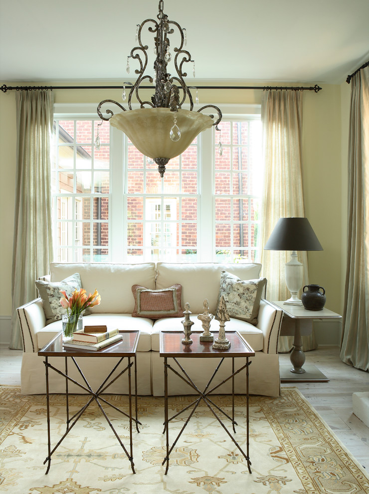 This is an example of a traditional living room in Atlanta with beige walls.