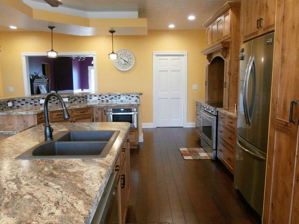 Inspiration for a large rustic single-wall dark wood floor and brown floor eat-in kitchen remodel with shaker cabinets, medium tone wood cabinets, laminate countertops, metallic backsplash, stainless steel appliances and two islands