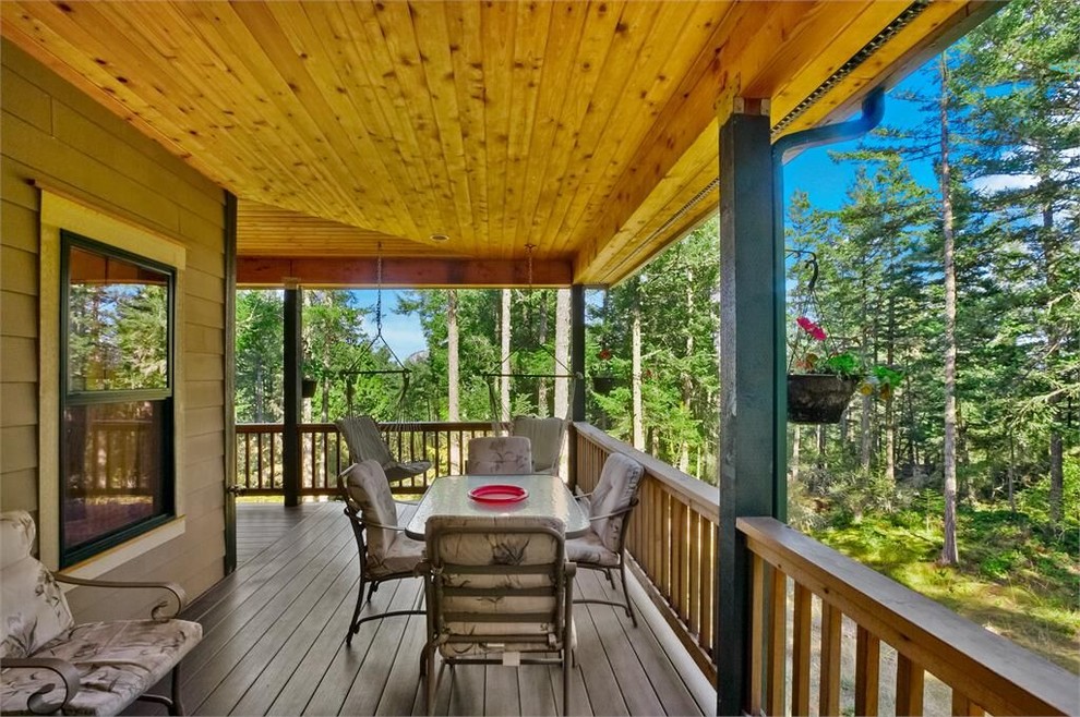 Deck - large side yard deck idea in Seattle with a roof extension