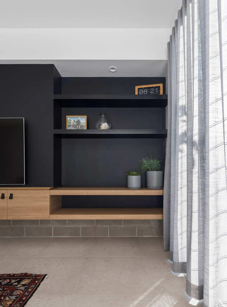 This is an example of a contemporary open concept living room with black walls, ceramic floors and a built-in media wall.