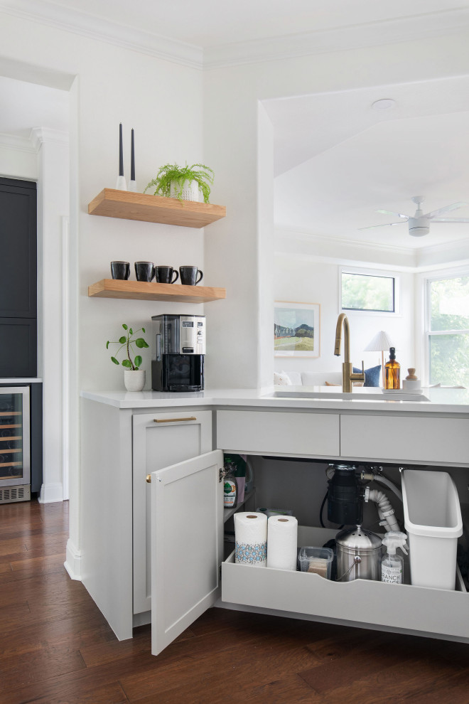 Mid-sized transitional medium tone wood floor and brown floor kitchen photo in Austin with an undermount sink, shaker cabinets, gray cabinets, quartz countertops, white backsplash, brick backsplash and white countertops