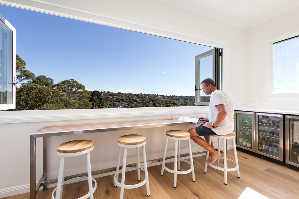 Design ideas for a beach style home bar in Sydney.