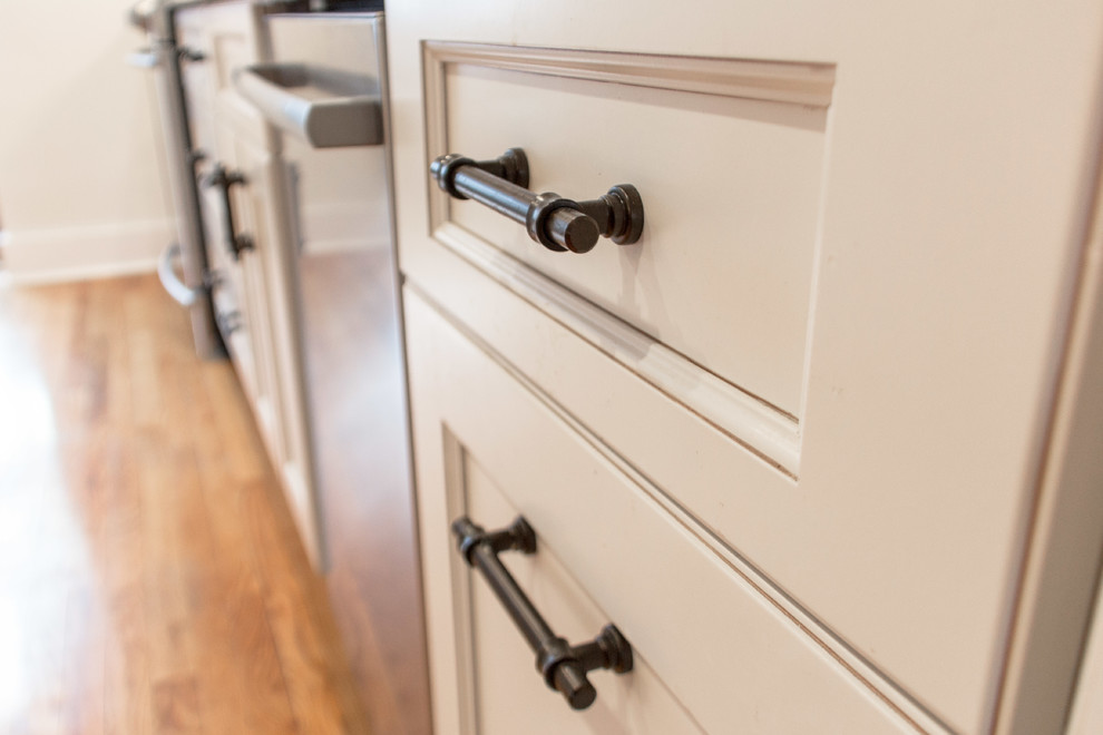 Inspiration for a transitional medium tone wood floor kitchen remodel with granite countertops, subway tile backsplash and stainless steel appliances