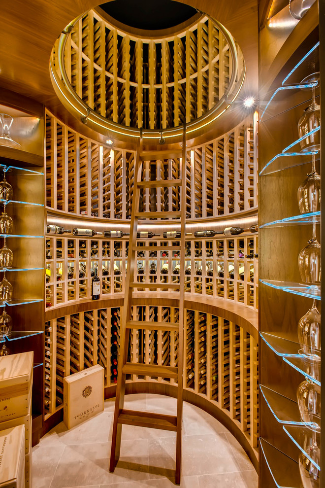 This is an example of a mediterranean wine cellar in Denver with storage racks and beige floor.