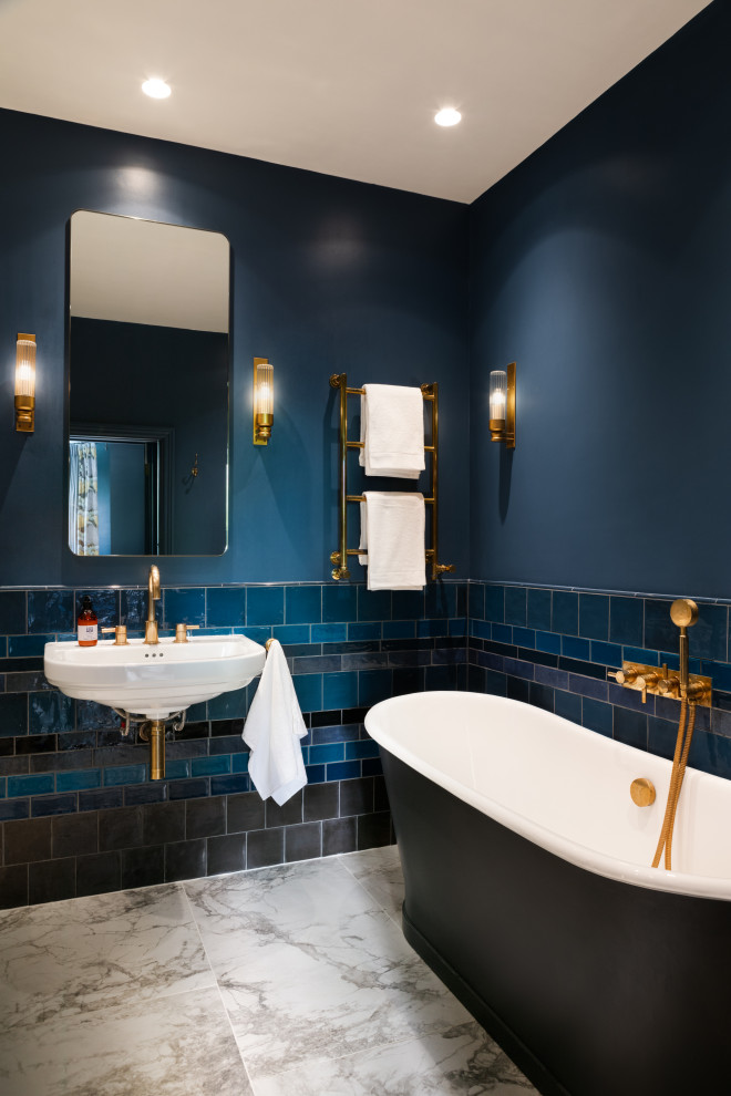 Medium sized traditional ensuite bathroom in London with a wall mounted toilet, porcelain flooring, a wall-mounted sink, an open shower, a dado rail and a single sink.