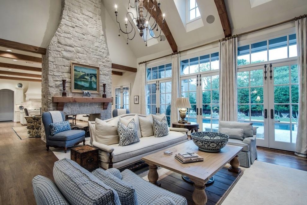 Inspiration for an expansive transitional formal open concept living room in Dallas with beige walls, medium hardwood floors, a two-sided fireplace, a stone fireplace surround and a built-in media wall.