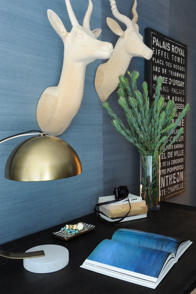 Photo of a medium sized bohemian study in Vancouver with blue walls, a freestanding desk, carpet and grey floors.