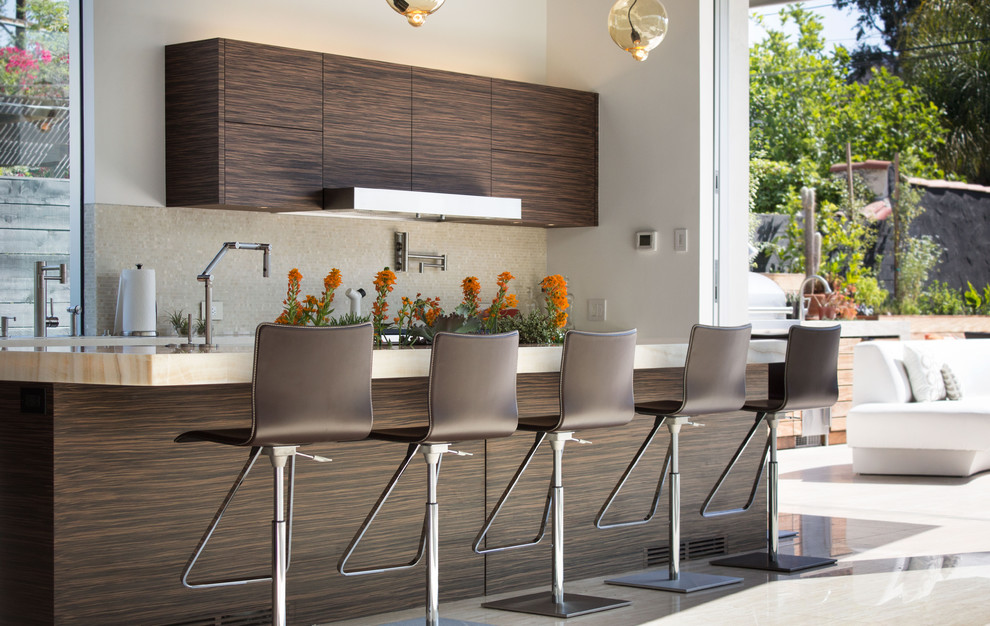 Contemporary kitchen in Los Angeles with flat-panel cabinets, dark wood cabinets, grey splashback and with island.