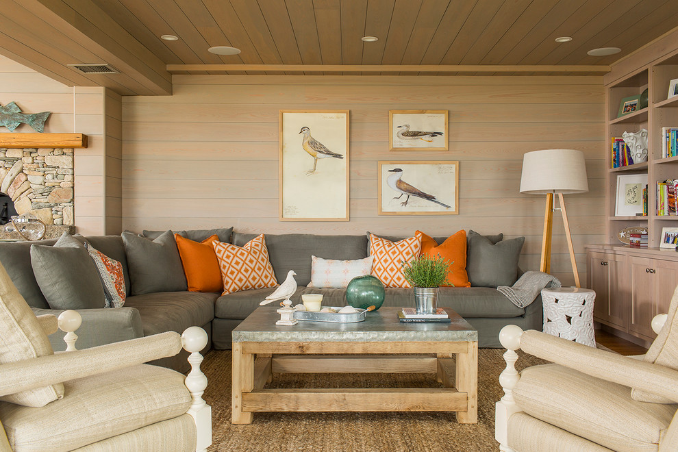 Inspiration for a beach style living room in Boston with a library, beige walls and medium hardwood floors.