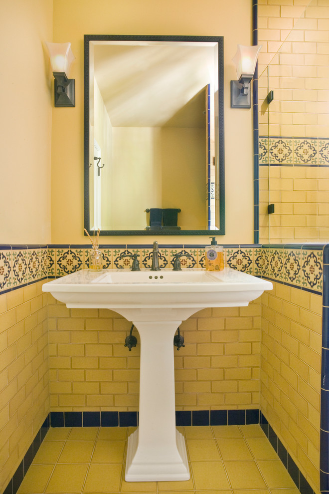 Photo of a mid-sized mediterranean 3/4 bathroom in Los Angeles with a pedestal sink, yellow tile, subway tile, beige walls and ceramic floors.