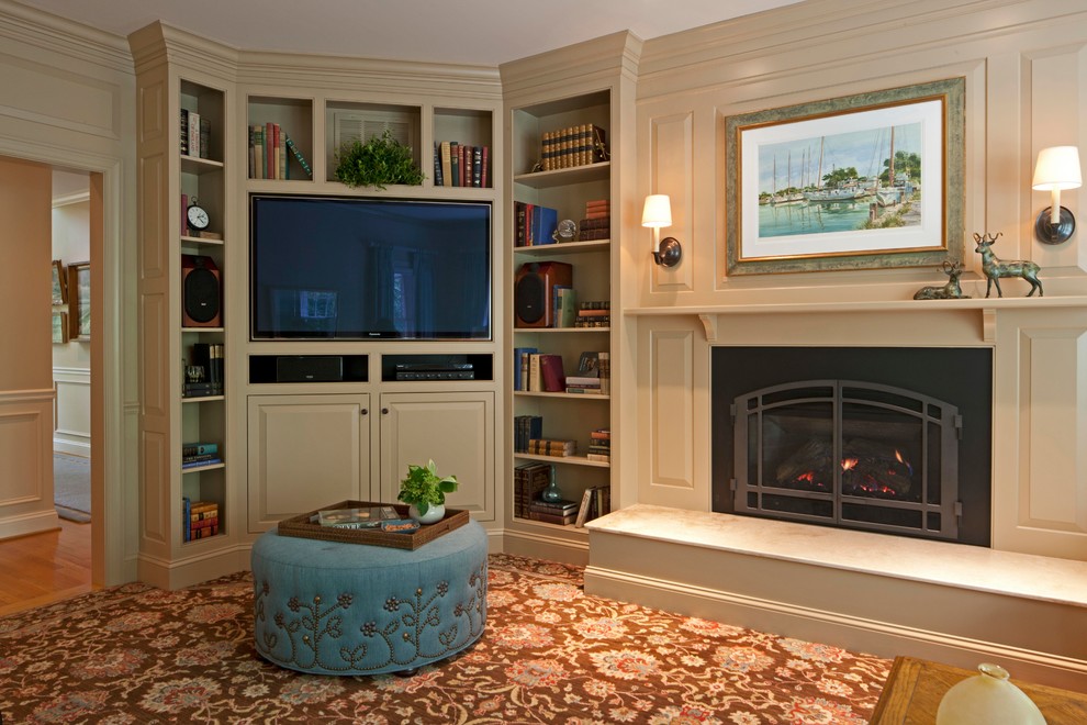 Inspiration for a mid-sized transitional enclosed family room in DC Metro with beige walls, carpet, a standard fireplace, a built-in media wall, a metal fireplace surround, a library and brown floor.