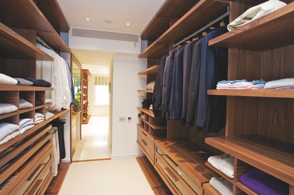 Photo of a contemporary men's walk-in wardrobe in London with open cabinets and medium wood cabinets.