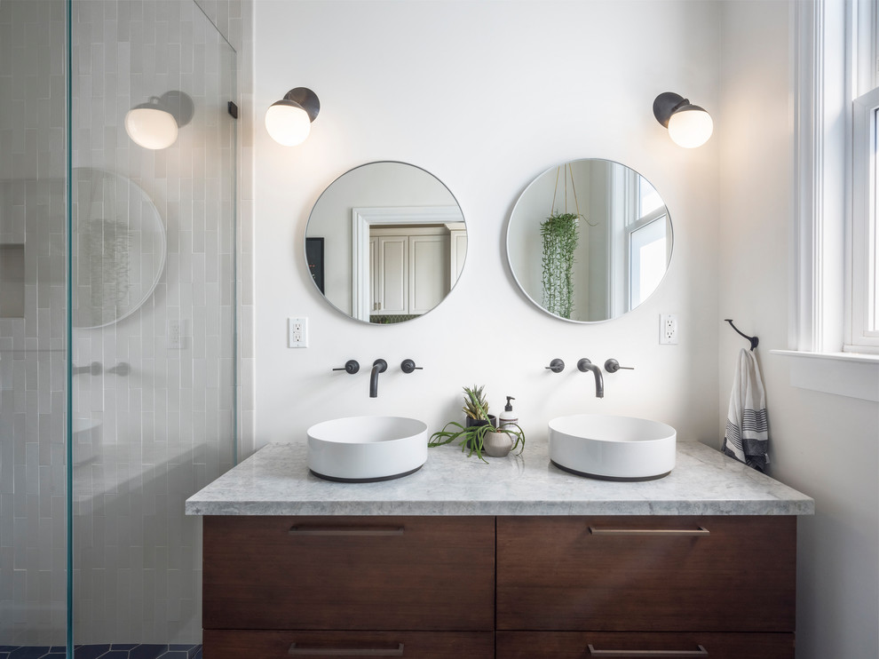 Mid-sized transitional bathroom in San Francisco with medium wood cabinets, ceramic tile, white walls, a vessel sink, engineered quartz benchtops, grey benchtops, flat-panel cabinets, an alcove shower and gray tile.