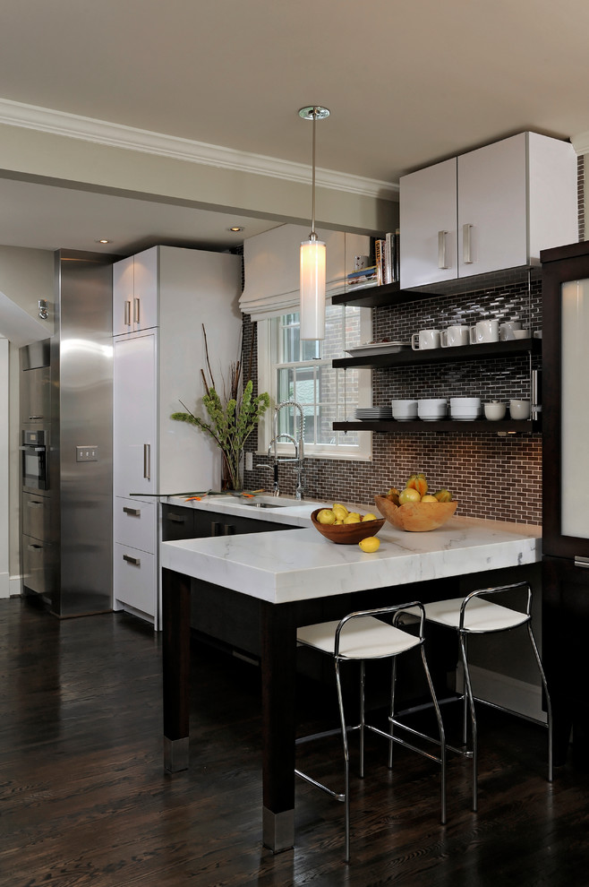 This is an example of a large contemporary l-shaped eat-in kitchen in DC Metro with panelled appliances, an undermount sink, flat-panel cabinets, marble benchtops, brown splashback, subway tile splashback, dark hardwood floors and a peninsula.