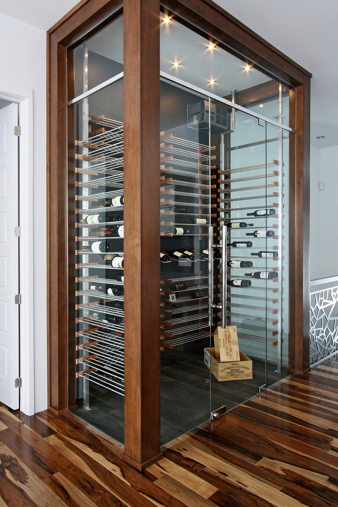 Inspiration for a mid-sized contemporary wine cellar in Phoenix with display racks, ceramic floors and beige floor.