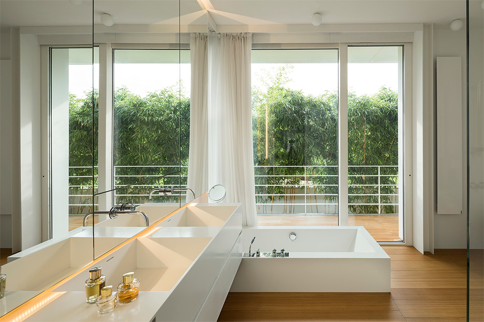 Large contemporary bathroom in Venice with flat-panel cabinets and white cabinets.