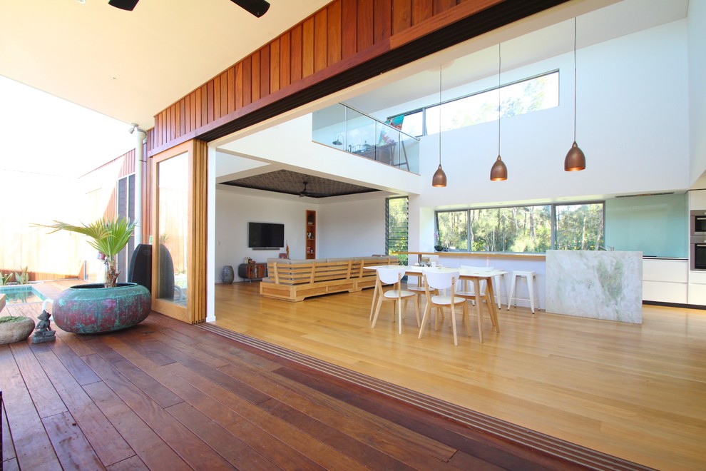 Inspiration for a large contemporary dining room in Sydney with white walls and light hardwood floors.