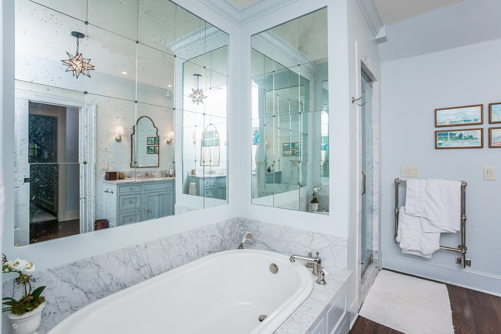 Inspiration for a large transitional master bathroom in Atlanta with beaded inset cabinets, grey cabinets, a drop-in tub, an alcove shower, grey walls, dark hardwood floors, an undermount sink, marble benchtops and a hinged shower door.