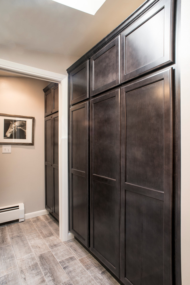 Photo of a mid-sized transitional kids bathroom in Denver with recessed-panel cabinets, dark wood cabinets, an alcove tub, an alcove shower, a two-piece toilet, gray tile, ceramic tile, grey walls, ceramic floors, an undermount sink and granite benchtops.