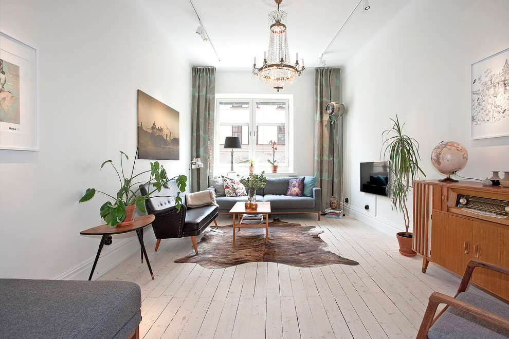 Photo of a mid-sized scandinavian formal enclosed living room in Malmo with white walls, painted wood floors, no fireplace and a wall-mounted tv.