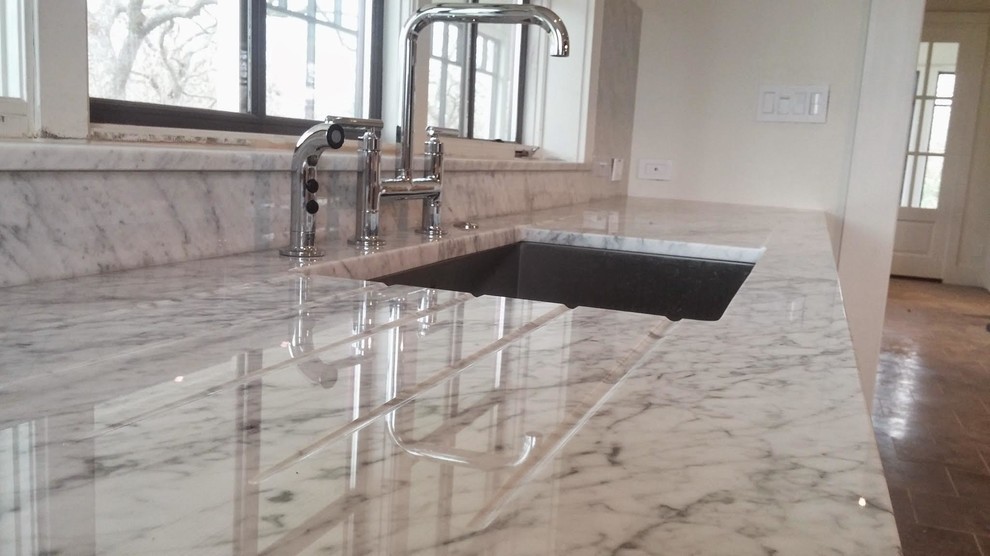 Open concept kitchen - mid-sized transitional porcelain tile open concept kitchen idea in Austin with an undermount sink, shaker cabinets, white cabinets, marble countertops, gray backsplash, marble backsplash and stainless steel appliances