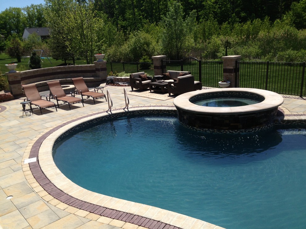 Hot tub - transitional backyard brick and custom-shaped hot tub idea in Detroit