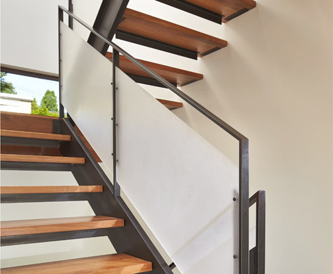 This is an example of a mid-sized modern wood u-shaped staircase in Seattle with open risers.