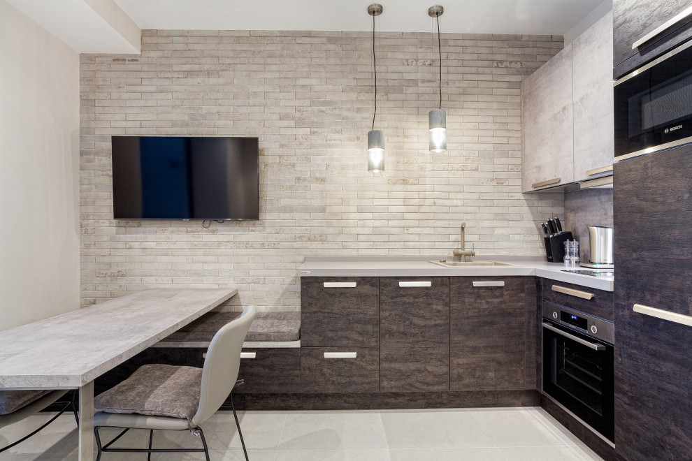 This is an example of a small urban l-shaped kitchen/diner in Other with a single-bowl sink, flat-panel cabinets, engineered stone countertops, brick splashback, stainless steel appliances, porcelain flooring, no island, grey floors, grey worktops and exposed beams.