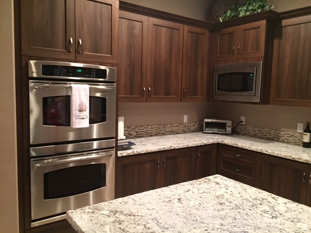 Inspiration for a mid-sized transitional l-shaped limestone floor and beige floor open concept kitchen remodel with an undermount sink, shaker cabinets, dark wood cabinets, granite countertops, multicolored backsplash, matchstick tile backsplash, stainless steel appliances and an island