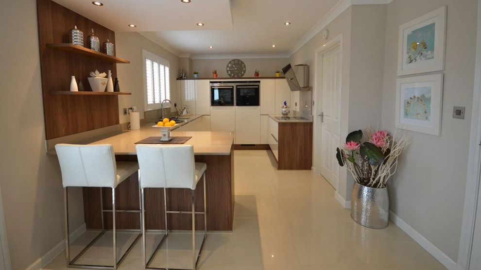 Photo of a mid-sized contemporary u-shaped eat-in kitchen in Other with a double-bowl sink, flat-panel cabinets, medium wood cabinets, laminate benchtops, white splashback, timber splashback, coloured appliances, marble floors, no island and white floor.