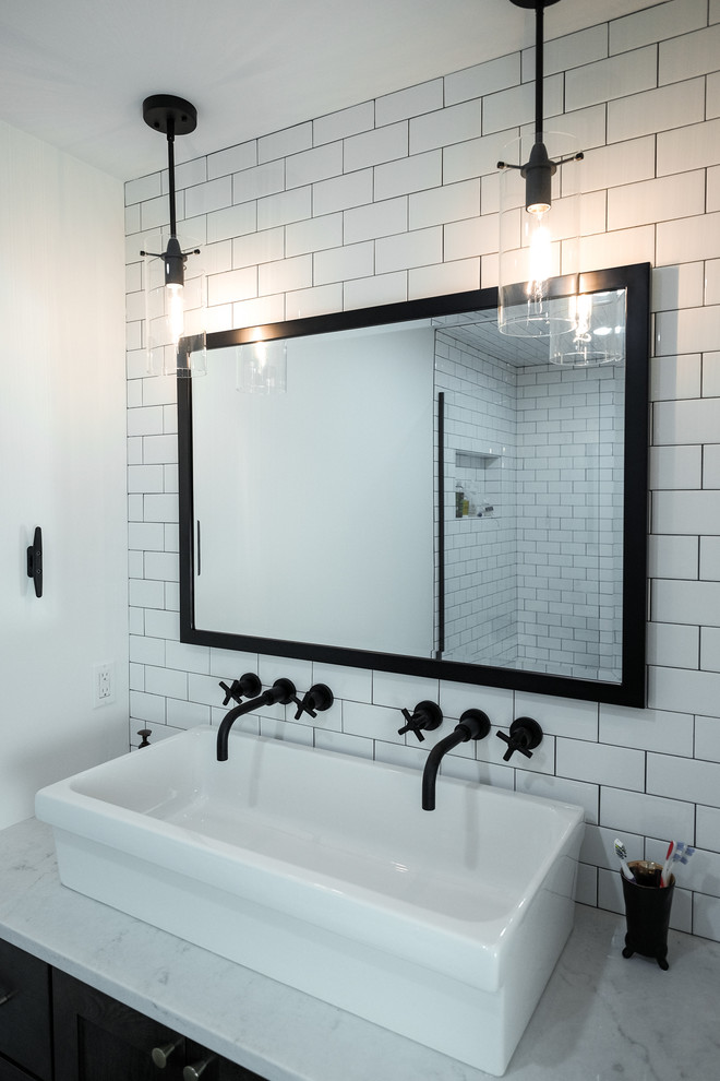 Example of a mid-sized urban subway tile corner shower design in Grand Rapids with white walls, a trough sink and marble countertops