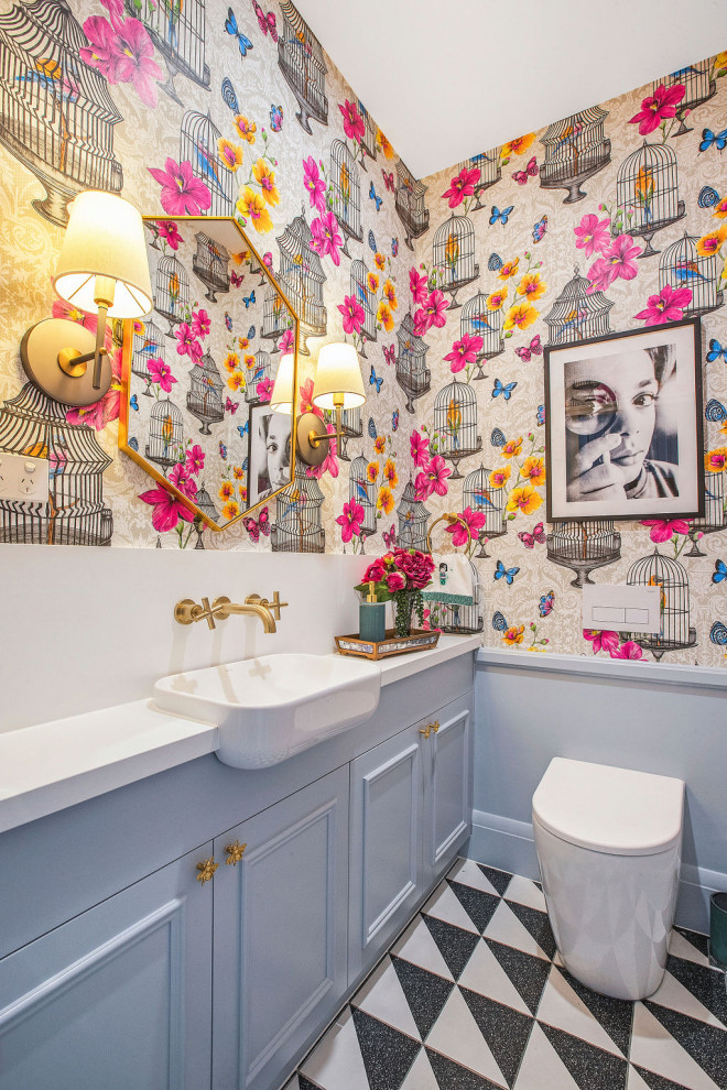 This is an example of a small eclectic powder room in Sydney with beaded inset cabinets, blue cabinets, a one-piece toilet, ceramic floors, a drop-in sink, engineered quartz benchtops and white benchtops.