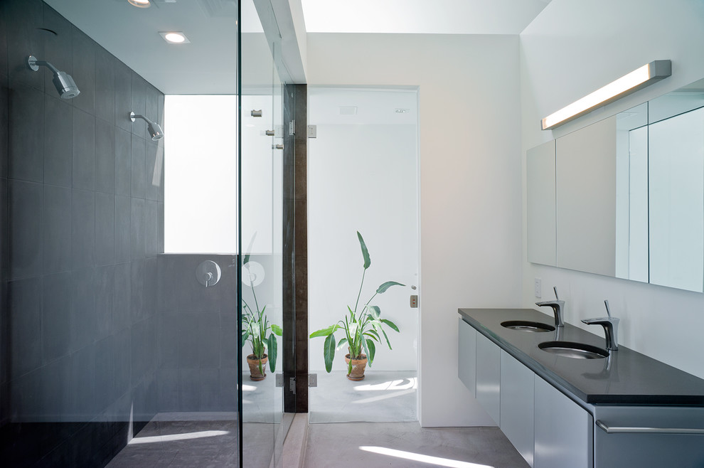 Design ideas for a large modern master bathroom in New York with flat-panel cabinets, grey cabinets, a double shower, grey walls, concrete floors, an undermount sink, engineered quartz benchtops, grey floor and a hinged shower door.