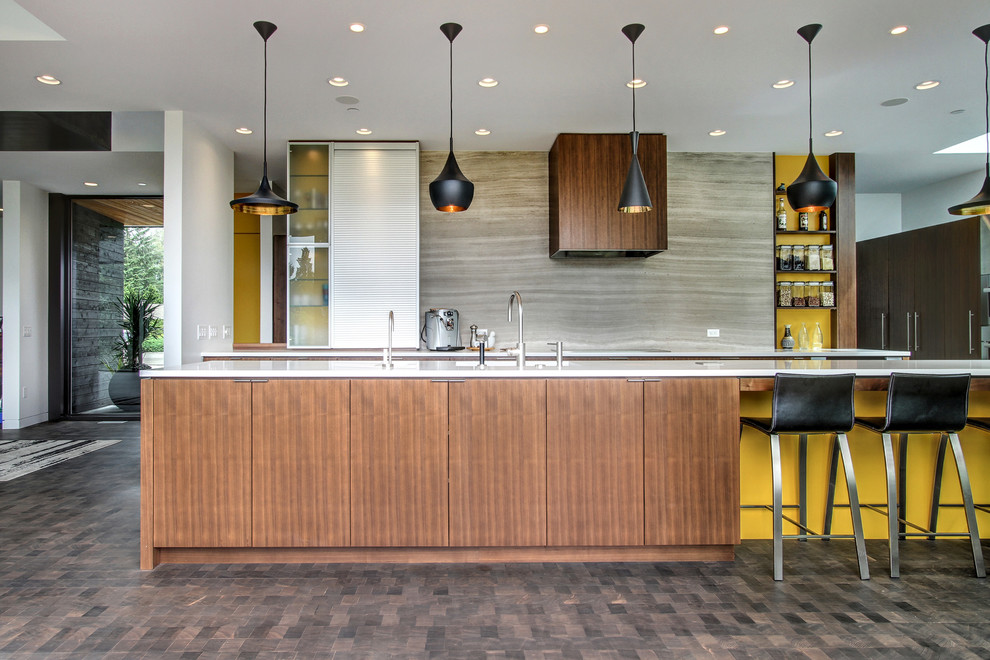 Mid-sized contemporary galley kitchen in Seattle with flat-panel cabinets, medium wood cabinets, solid surface benchtops, dark hardwood floors, with island and grey splashback.