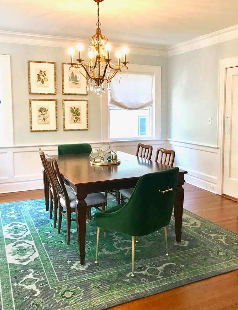 This is an example of a mid-sized transitional separate dining room in New York with blue walls, medium hardwood floors, no fireplace and brown floor.