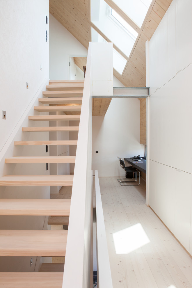 This is an example of a scandinavian wood straight staircase in Stuttgart.